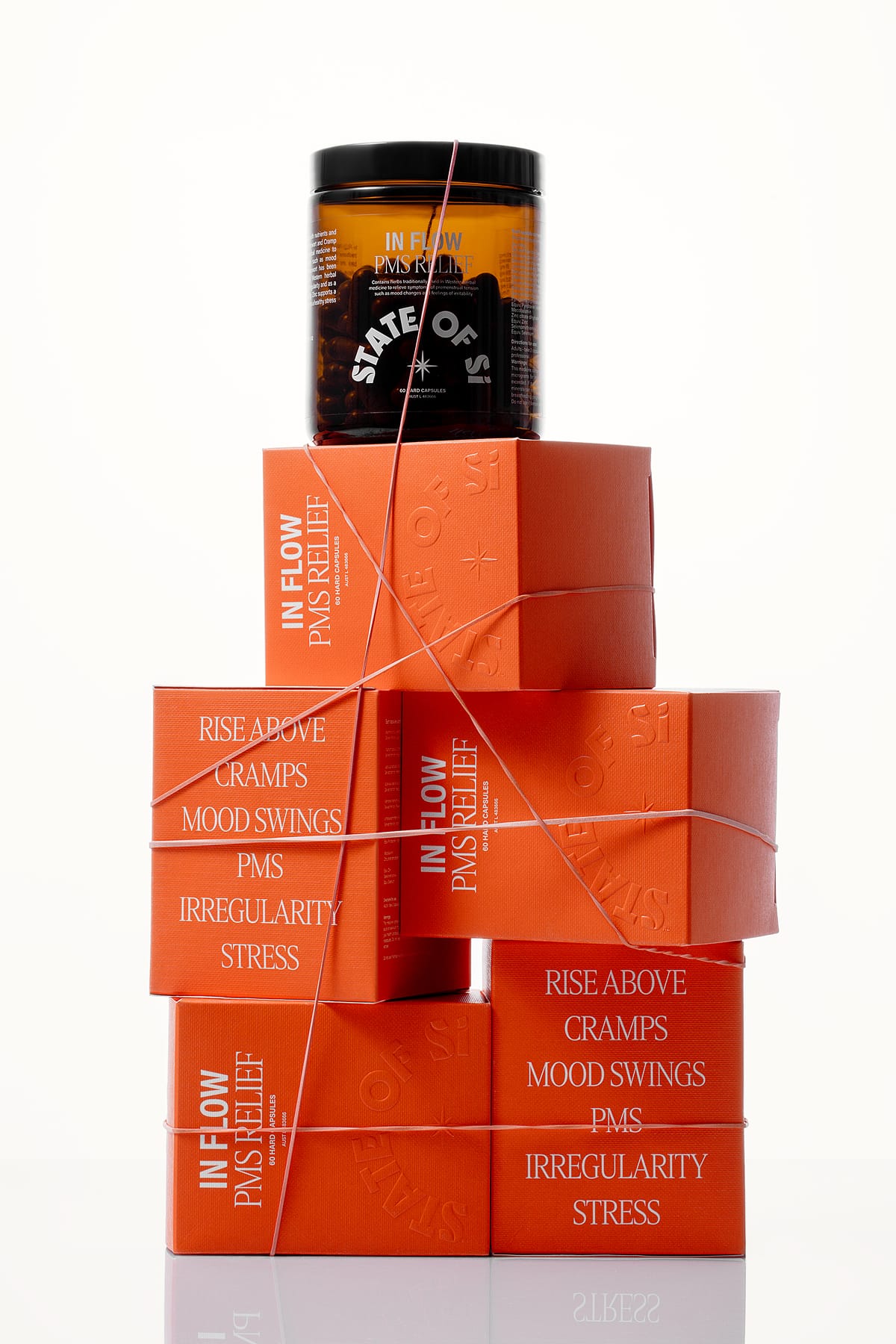 Orange boxes of In Flow PMS Relief wrapped in string against a white background